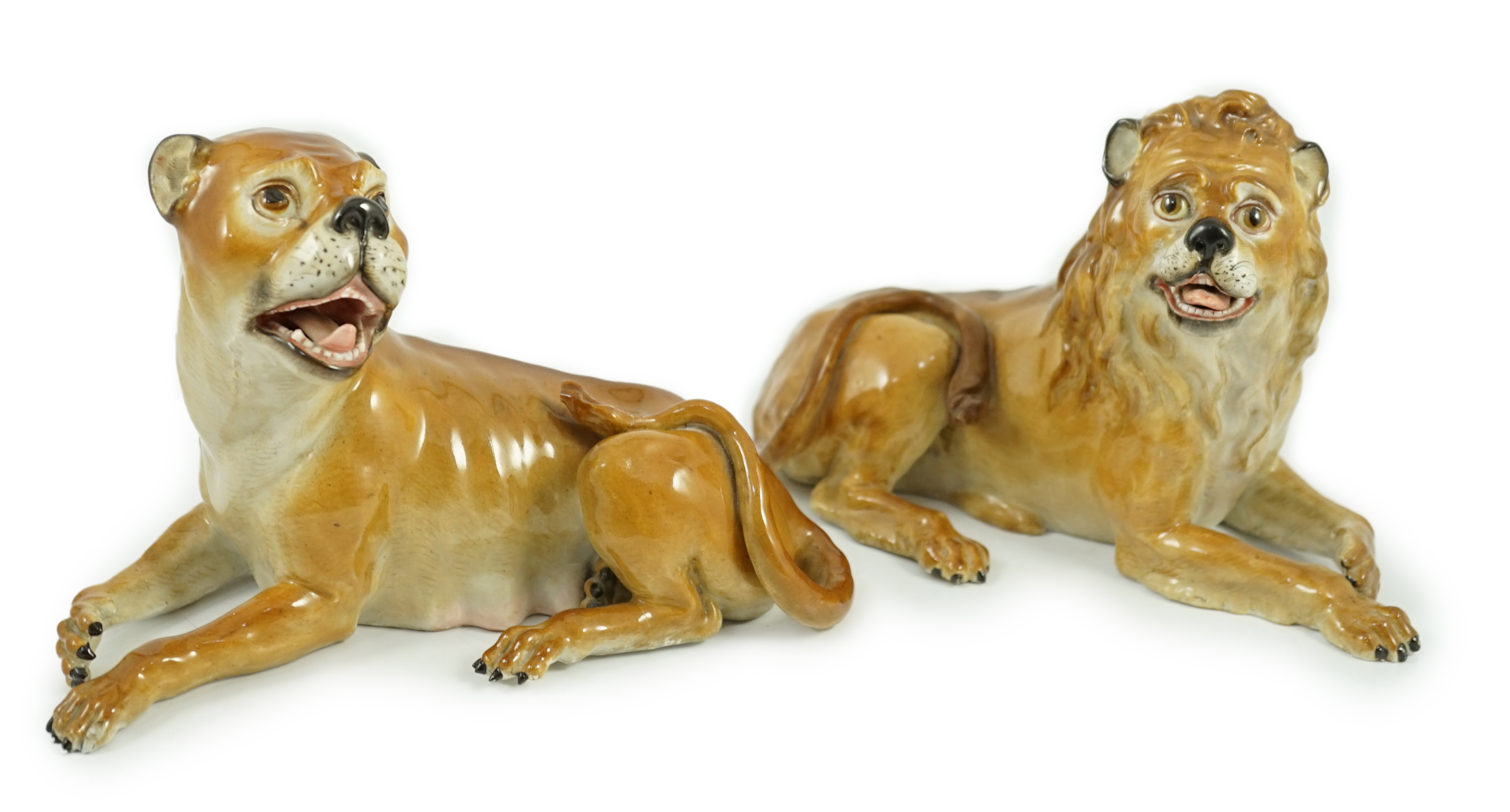 A pair of Meissen figures of a recumbent lion and lioness, 19th century, restoration